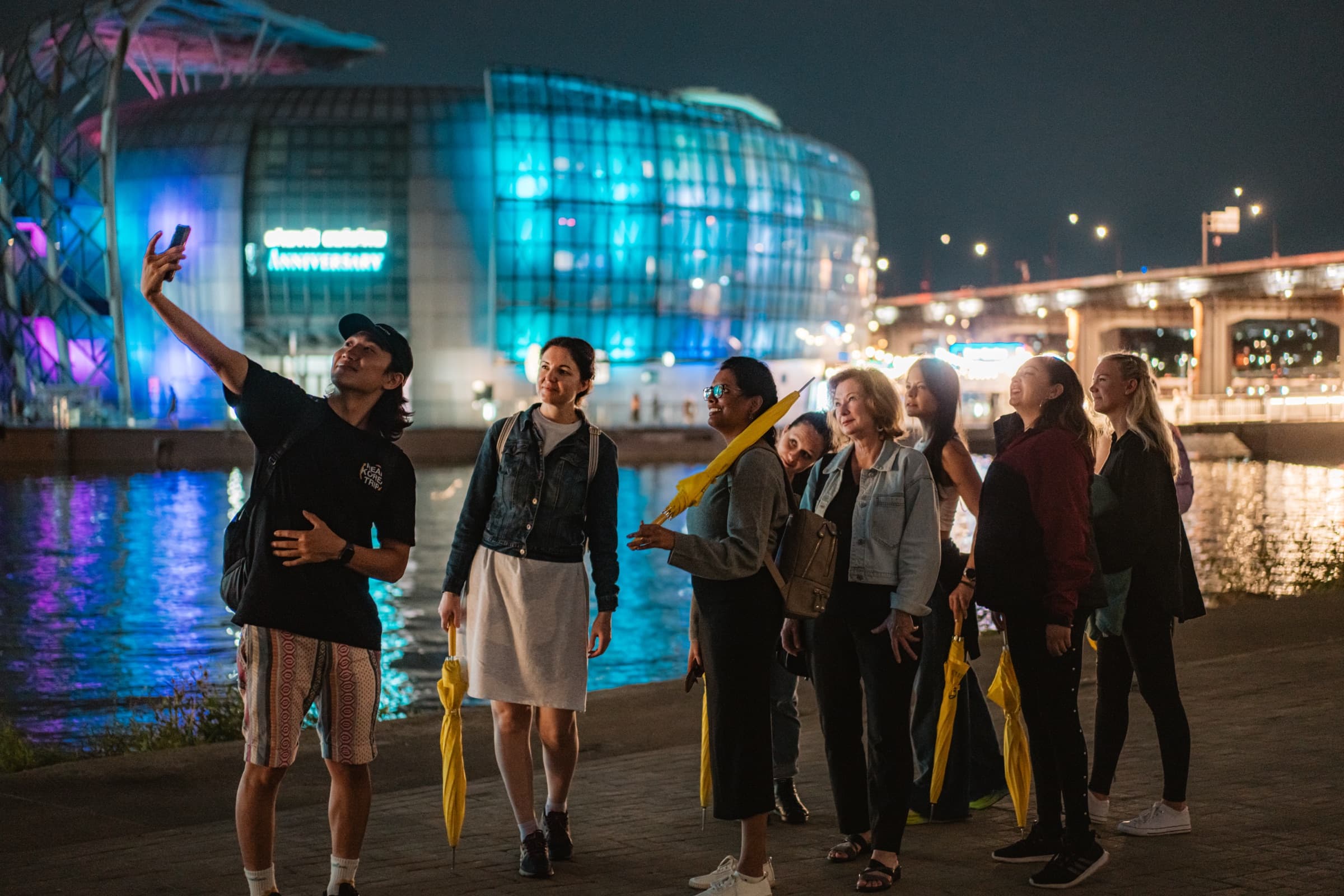 The group taking a selfie by the Seoul river at night